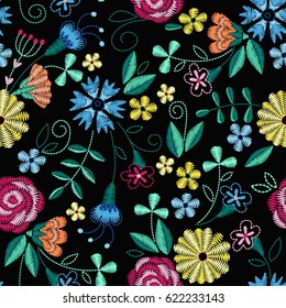 Embroidery seamless pattern with beautiful flowers. Vector floral ornament on black background. Embroidery for fashion textile and fabric.