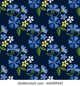Embroidery seamless pattern with beautiful flowers. Vector floral ornament on dark blue background. Embroidery for fashion textile and fabric.