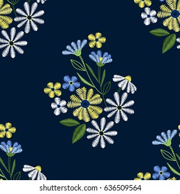 Embroidery seamless pattern with beautiful flowers. Vector floral ornament on dark blue background. Embroidery for fashion textile and fabric.