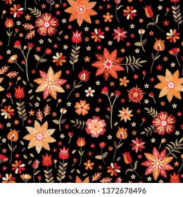 Embroidery seamless pattern in folk style. Stylized flowers and leaves on black background. Vector illustration. Fashion design.