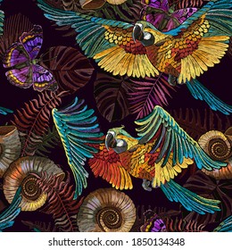 Embroidery. Seamless pattern. Macaws. Jungle paradise art. Tropical parrots, butterflies and palm leaves. Fashionable template for design of clothes 