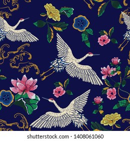 Embroidery seamless pattern with oriental cranes, waves and flowers. Vector embroidered floral patch.