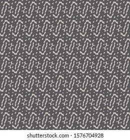 Embroidery in shades of brown and beige with a pattern consisting of small spots and simple abstract aligned signs. Decorative graphics made from dots.