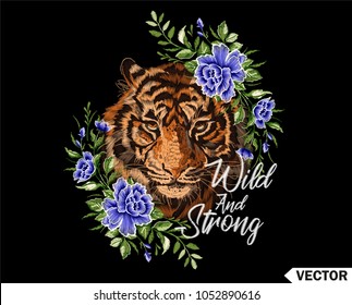 Embroidery tiger. Portrait of beautiful tiger and blue flowers template for fashion clothes, textiles, prints, t-shirt design. Slogan wild and strong