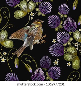 Embroidery titmouse and clover seamless pattern. Fashionable template for design of clothes. Classical beautiful flowers clover 