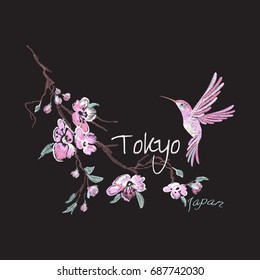 Embroidery trend floral pattern with flowers and hummingbird. Vector traditional embroidered cherry blossom and bird on black background for design.