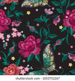 Embroidery trend floral seamless pattern with roses and exotic butterflies. Vector traditional folk flowers decor on black background for clothing design.