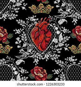 Embroidery trend floral seamless pattern with red rose, heart, lace and crown. Vector traditional folk flowers decor on black background for clothing design.