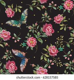 Embroidery trend floral seamless pattern with roses and exotic butterflies. Vector traditional folk flowers decor on black background for clothing design