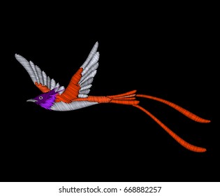 Embroidery tropical exotic bird isolated on black background.