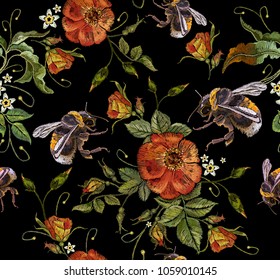 Embroidery wild roses flowers and bumblebees. Classic style embroidery, beautiful dogrose pattern vector. Vintage buds of wild roses on black background. Fashionable template tapestry flowers 