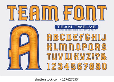 An embroidery-style alphabet in blue and yellow on a white background. This font is ideal for sports team style logos or insignias, as seen on caps and letter jackets.