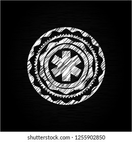 emergency cross icon drawn on a blackboard