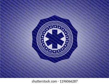 emergency cross icon inside badge with jean texture