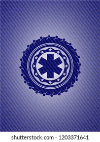 emergency cross icon inside badge with denim background