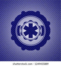 emergency cross icon inside badge with denim background