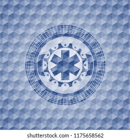 emergency cross icon inside blue emblem or badge with abstract geometric pattern background.