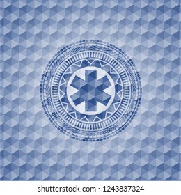 emergency cross icon inside blue emblem with geometric background.