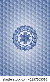emergency cross icon inside blue emblem with geometric background.