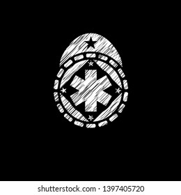 emergency cross icon inside chalkboard emblem on black board