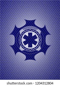 emergency cross icon inside emblem with jean texture