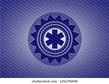 emergency cross icon inside emblem with jean background