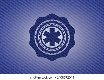 emergency cross icon inside emblem with jean background