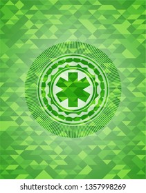 emergency cross icon inside green mosaic emblem
