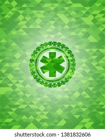 emergency cross icon inside green emblem with triangle mosaic background