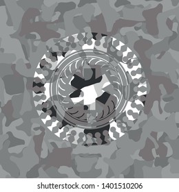 emergency cross icon inside grey camouflaged emblem