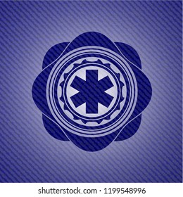 emergency cross icon inside jean or denim emblem or badge background
