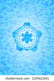 emergency cross icon inside light blue emblem with mosaic background