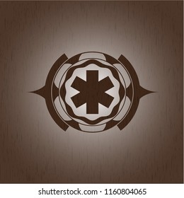 emergency cross icon inside retro style wooden emblem