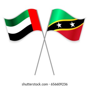 Emirian and Kittitian crossed flags. United Arab Emirates combined with Saint Kitts and Nevis isolated on white. Language learning, international business or travel concept.