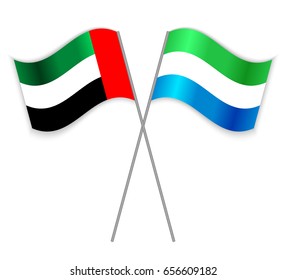 Emirian and Sierra Leonean crossed flags. United Arab Emirates combined with Sierra Leone isolated on white. Language learning, international business or travel concept.