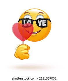 Emoji in sunglasses with an inscription - love. Romantic emoticon holds in hand a big red heart shaped lollipop. Vector illustration