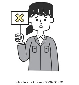  An employee of a construction shop holding a tag with a cross