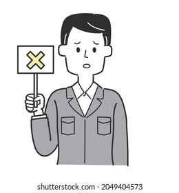  An employee of a construction shop holding a tag with a cross