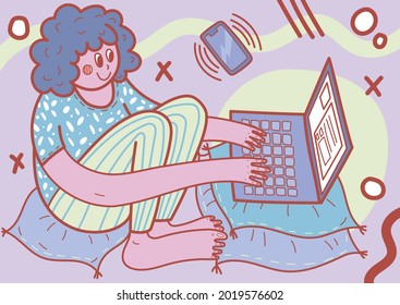 An employee works remotely at a laptop in home clothes with pillows