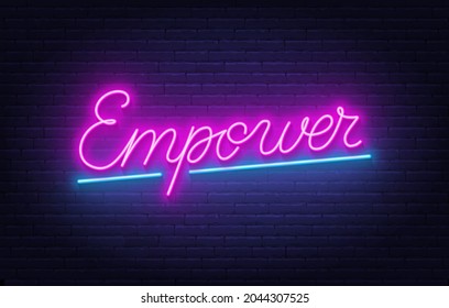 Empower neon lettering on brick wall background.