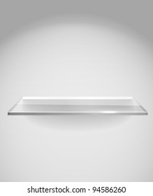 Empty advertising glass shelf withh a spot lignt