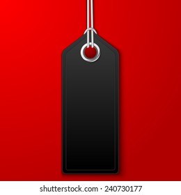 Empty black label or price tag with cord, isolated on red background