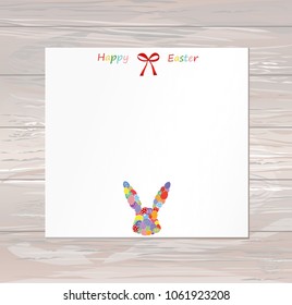 Empty blank for messages or greetings for Easter. Eggs with a pattern in the form of a bunny. Card for the holiday with a rabbit. Vector on wooden background.