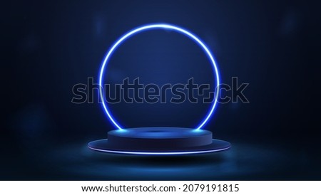Empty blue podium floating in the air with blue neon ring on background.