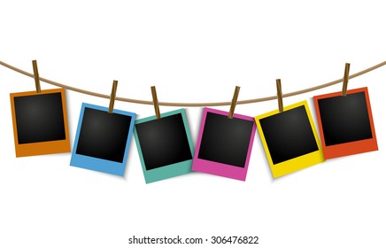 Empty colorful photo frames hanging on rope with pin