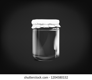 Empty glass jar isolated on dark background.