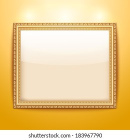 Empty gold frame hanging on the wall