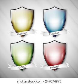 Empty isolated colored shields on dirty gray background. Vector format.