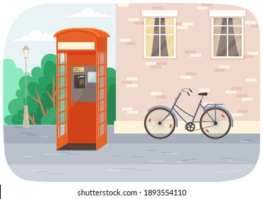 Empty London red classic telephone booth with an open door on the street with a bicycle at the building. City summer landscape with public telephone and brick wall with windows, Empty urban street