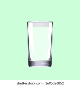 An empty medium-sized glass cup on a light green background.